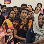 students attentively listening to the Chief Guest